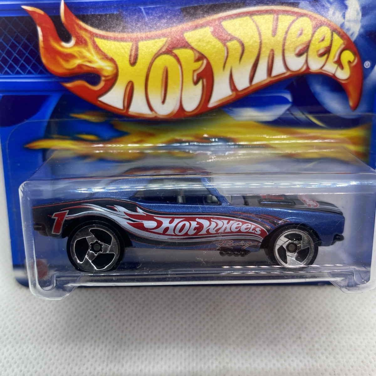 Close view of Hot Wheels blue Camaro 1967 die-cast toy car in clear blister