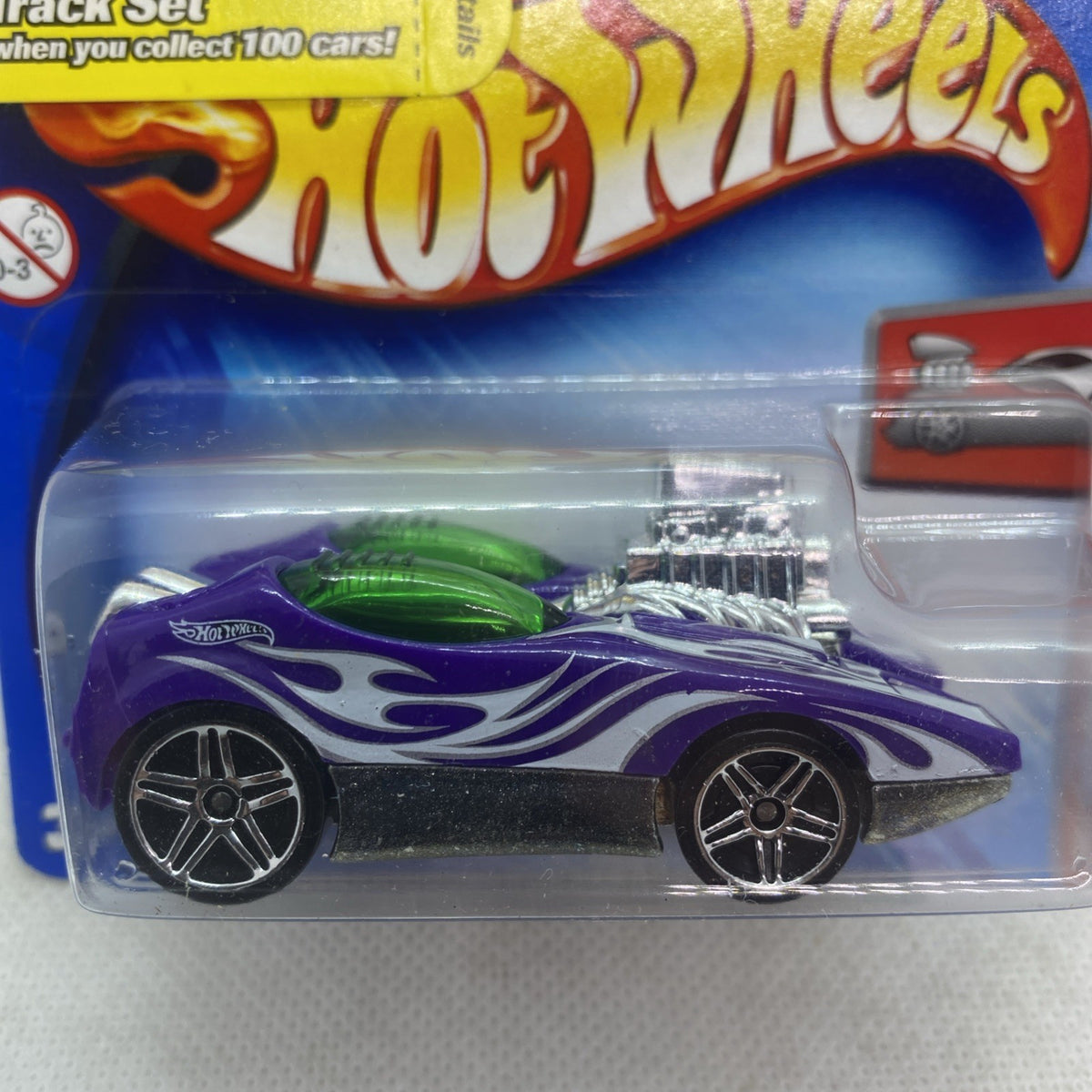 Hot Wheels purple flame die-cast car with green details, sealed in clear blister