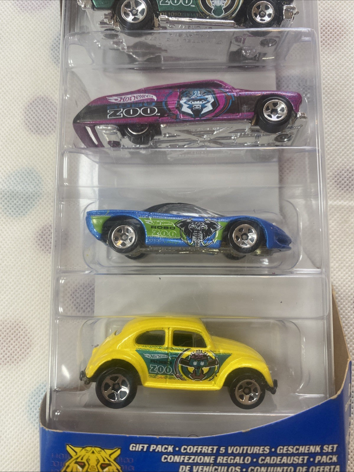 Diecast blister showing purple, blue, and yellow cars with ZOO graphics