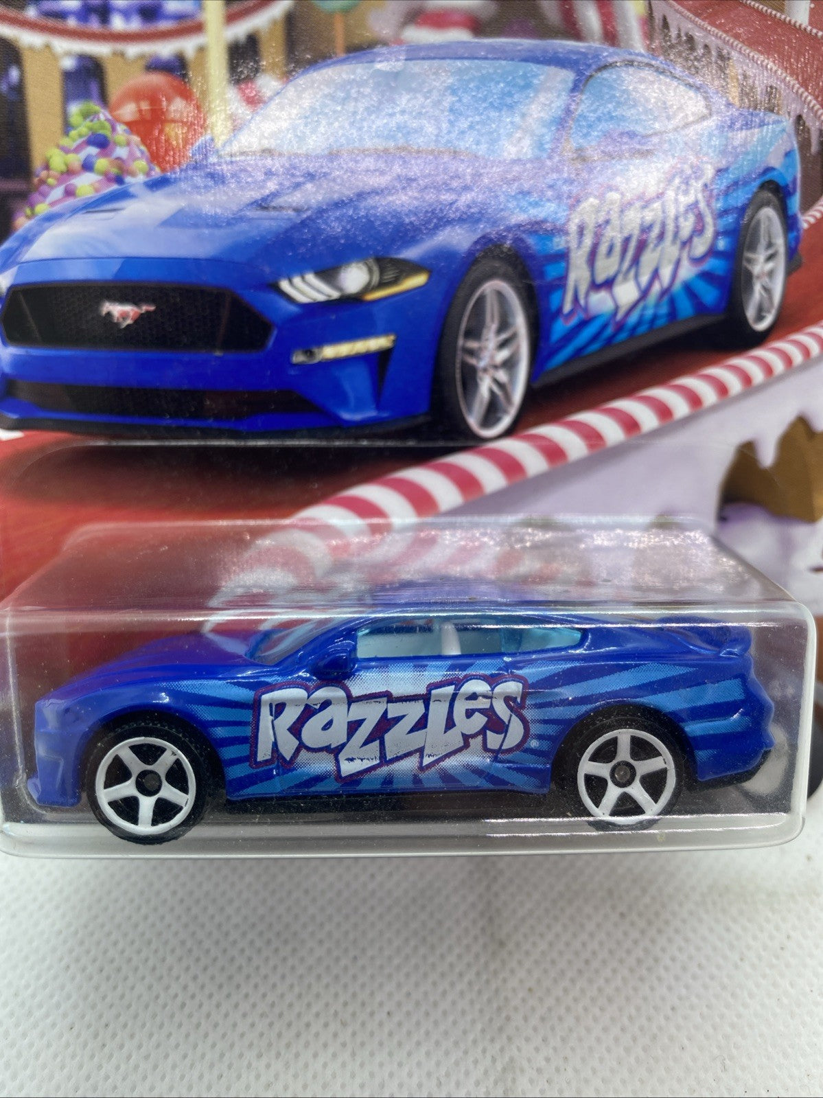 Close-up of blue Matchbox "Razzles" toy car in clear plastic blister pack