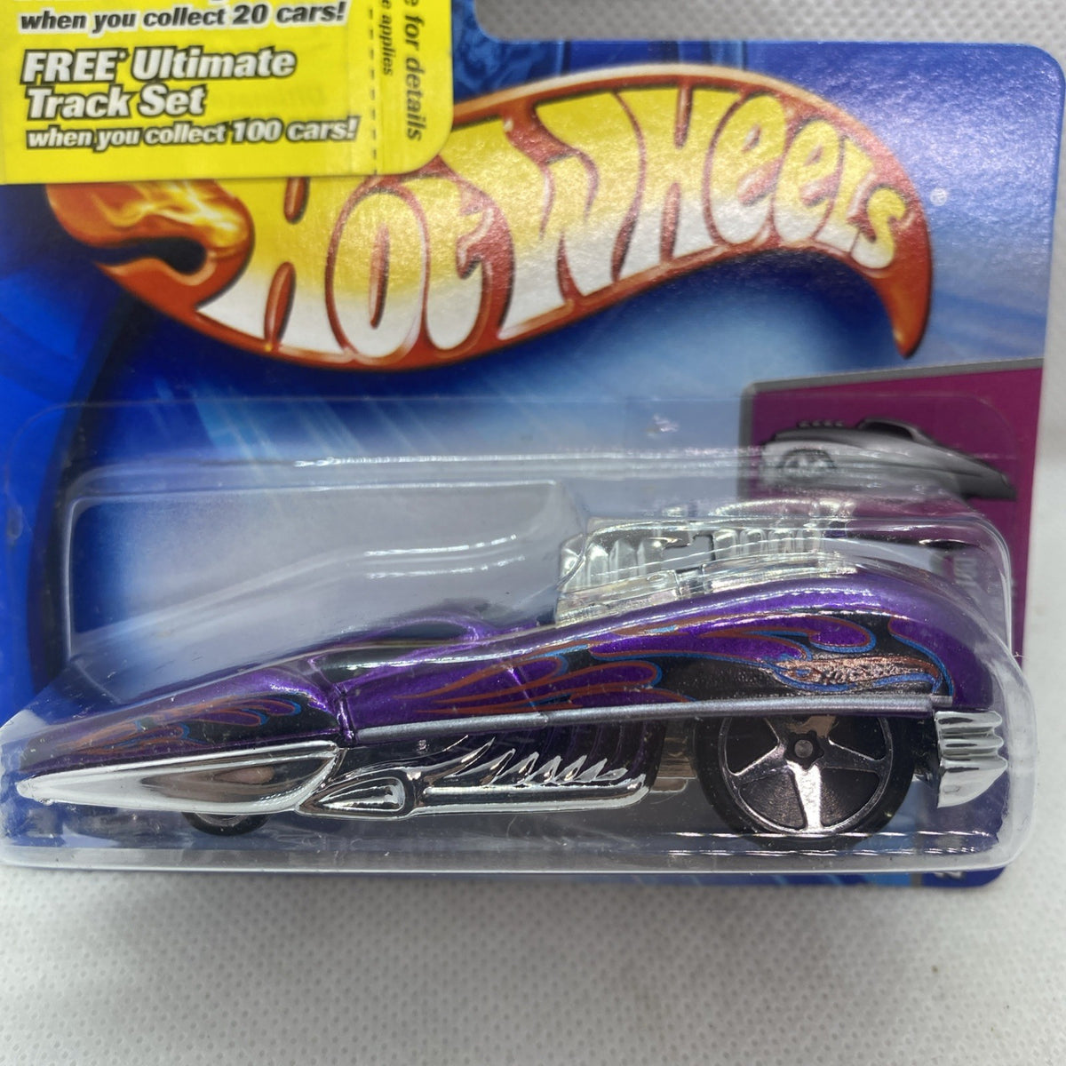 Hot Wheels die-cast car in blister, black car with purple flame graphics on blue card