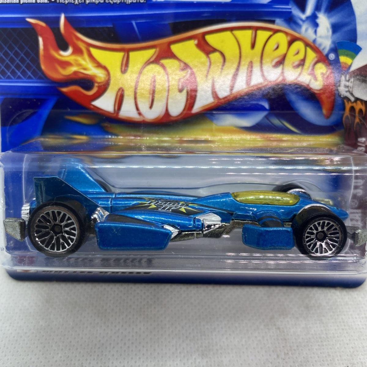 Close-up of blue die-cast race car in clear blister pack on blue card