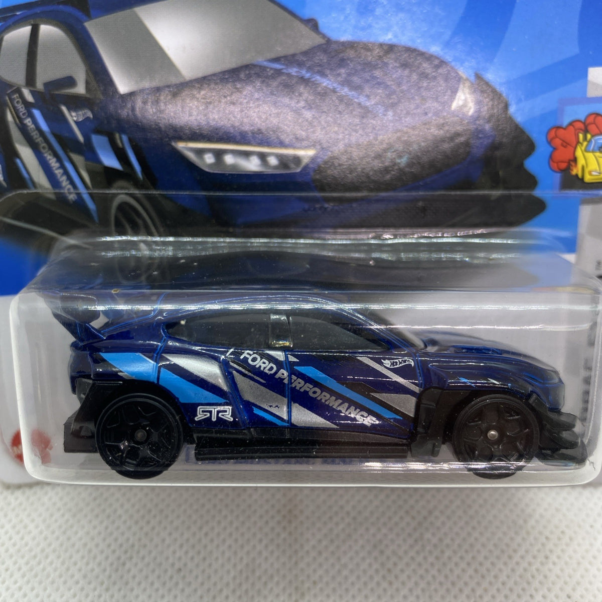 Blue and black Hot Wheels die-cast toy car inside clear plastic blister