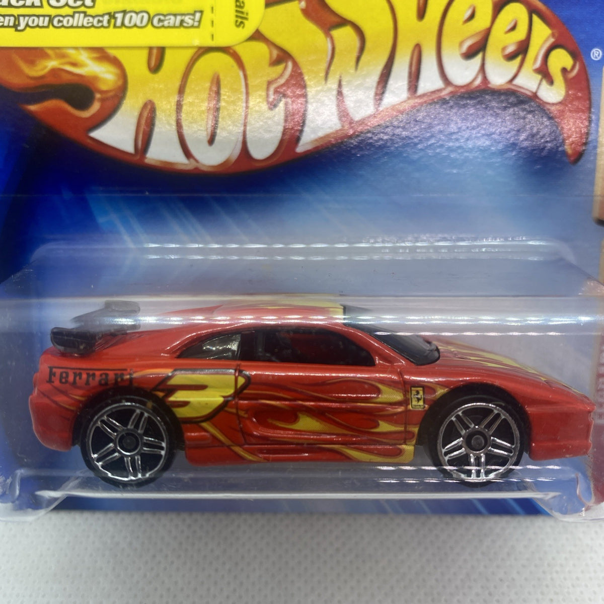 Close-up of red Hot Wheels Ferrari die-cast car in clear blister packaging