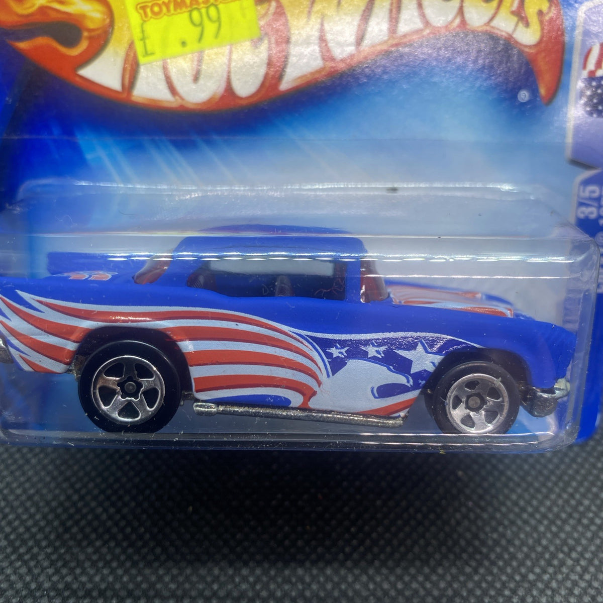 Hot Wheels 1957 Chevy die-cast close-up on card, side with stars, stripes, and flames