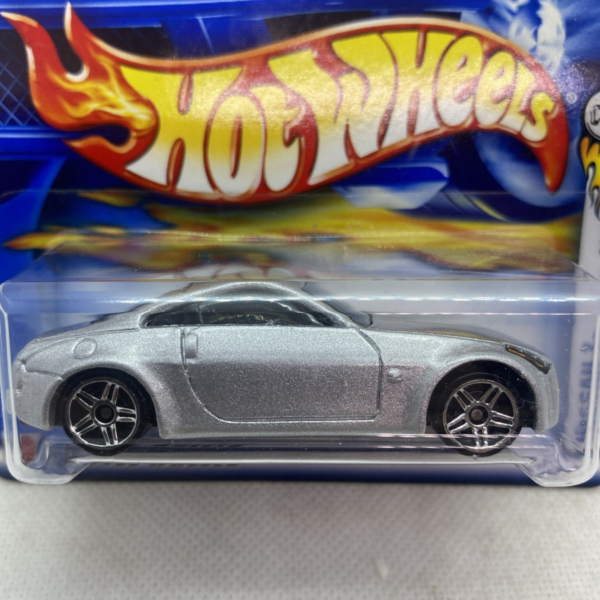 Hot Wheels die-cast Nissan Z 2002 silver-gray car close-up in clear blister