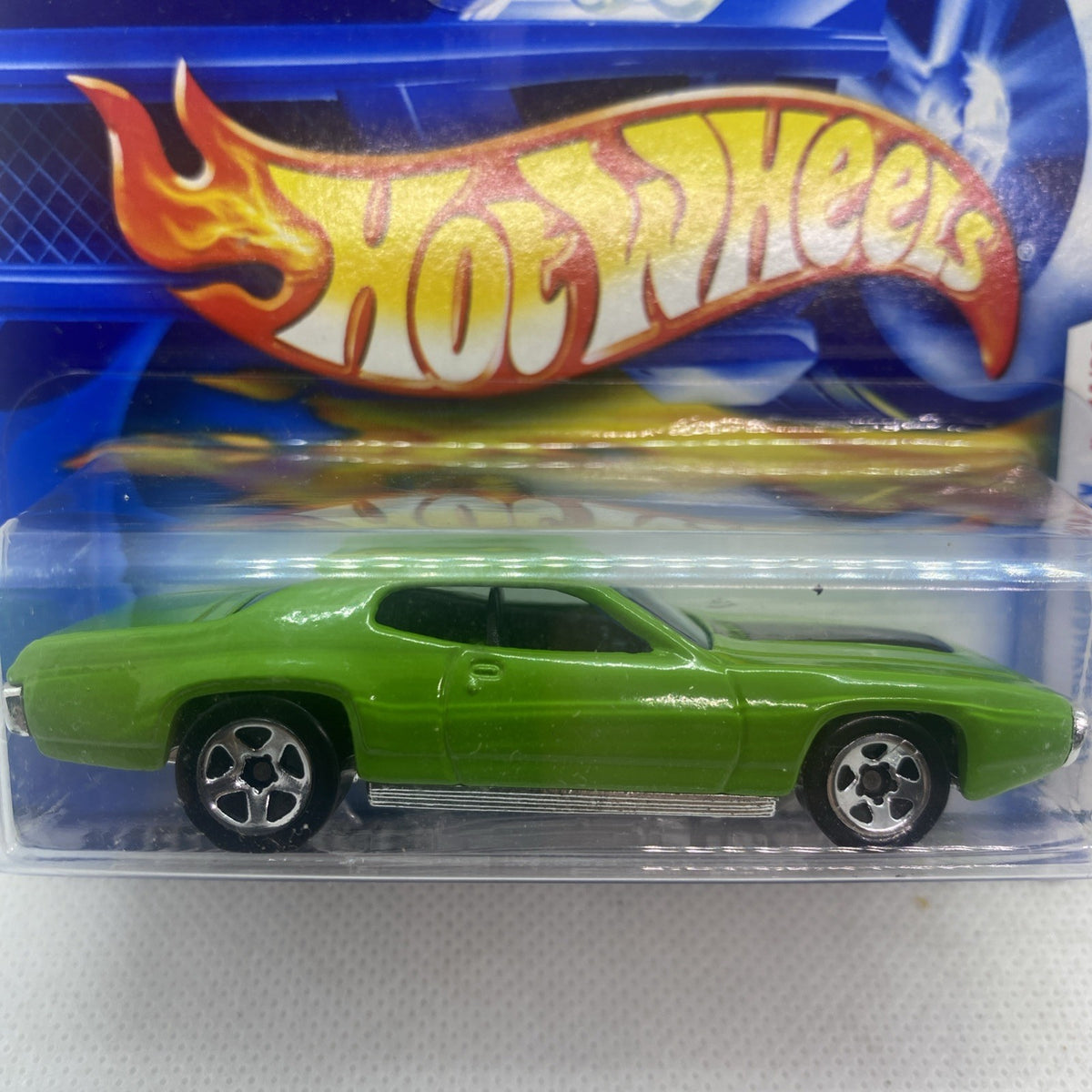 Lime green toy car side view in clear blister with flame logo graphics