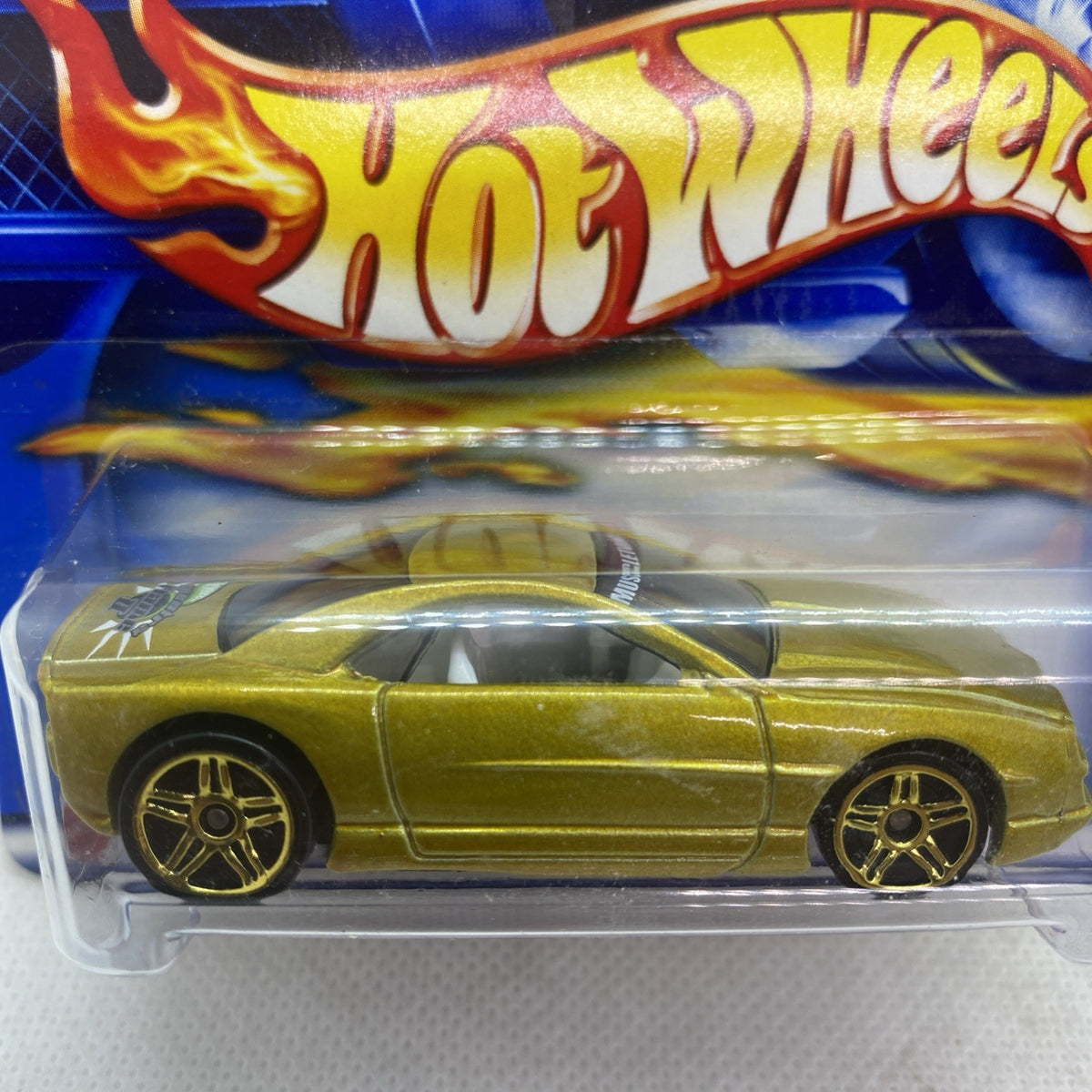 Metallic yellow-green muscle car toy with black wheels in clear blister