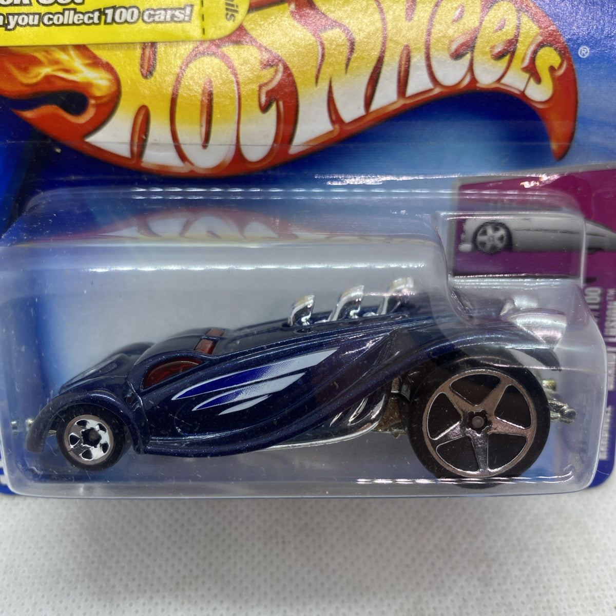 Hot Wheels die-cast car close-up in blister, dark blue with flame-style graphics