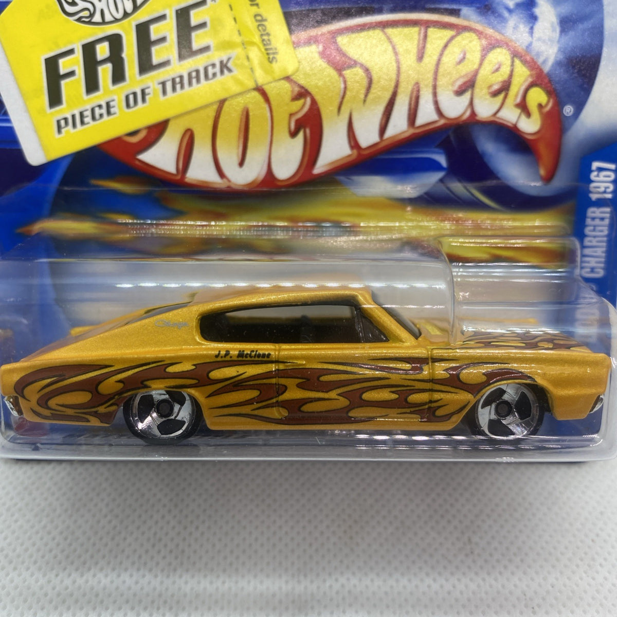 Close-up of yellow flame-graphic Hot Wheels die-cast car in clear blister pack