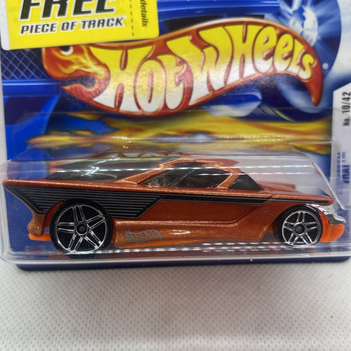 Hot Wheels die-cast car on short card with orange-brown body, black wheels, flames