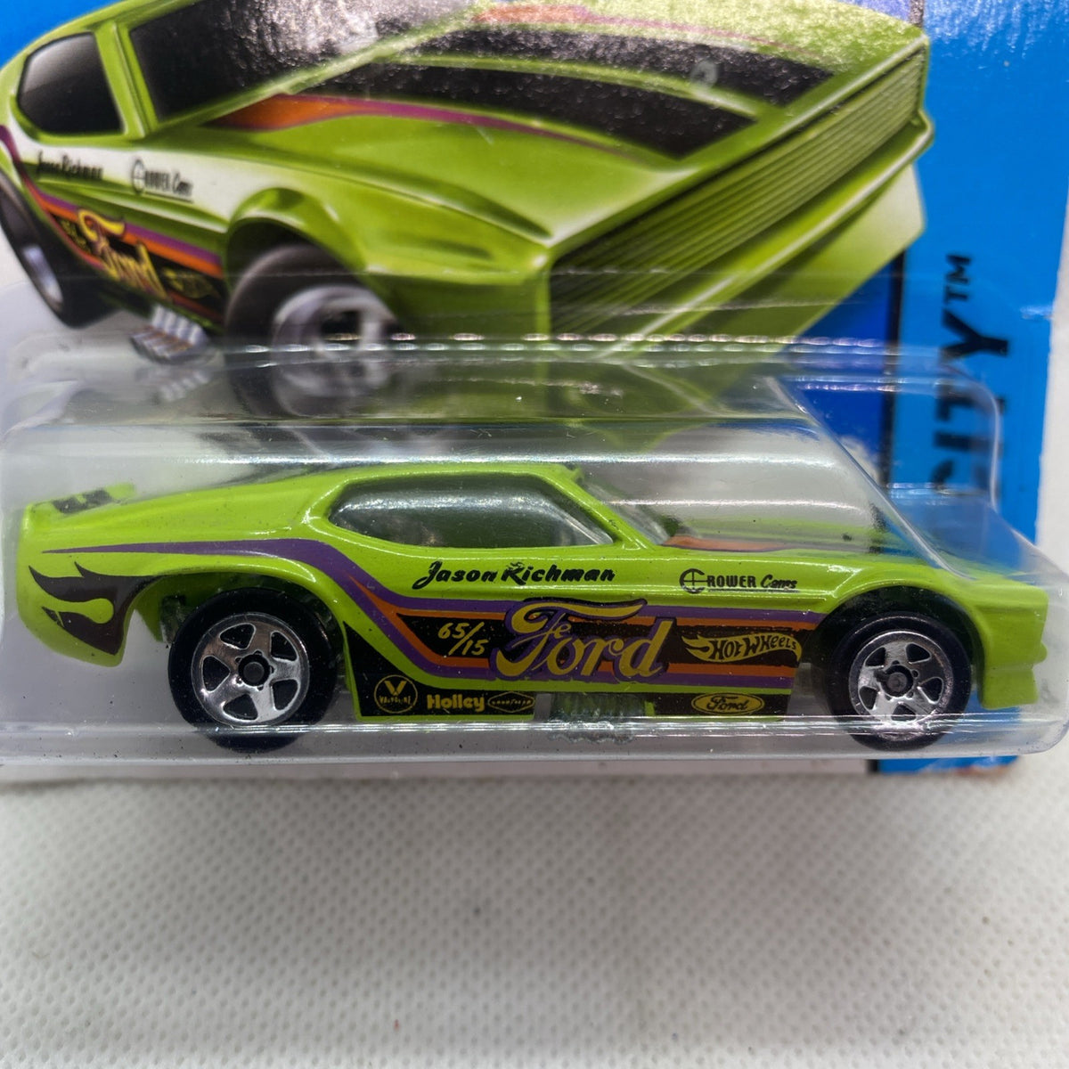 Close-up of lime green die-cast toy car in blister, Ford logo and sponsor text