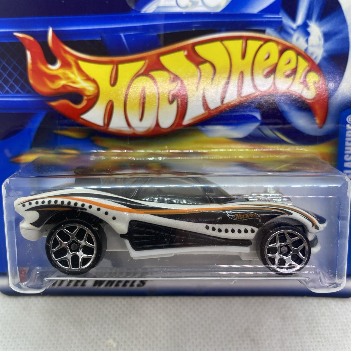 Close-up Hot Wheels car blister on blue card, white race car with black details