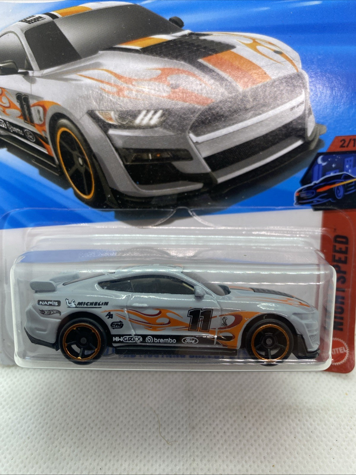 Hot Wheels die-cast car close-up on blister card with orange flame stripes