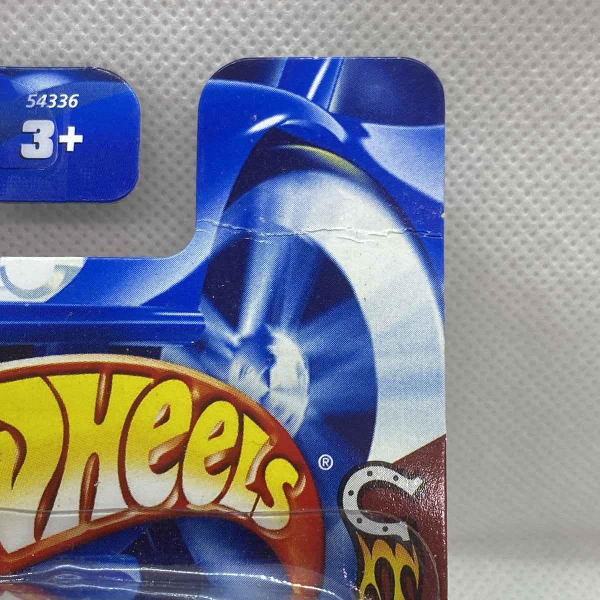 Hot Wheels blister pack close-up with blue flames and "3+" age label