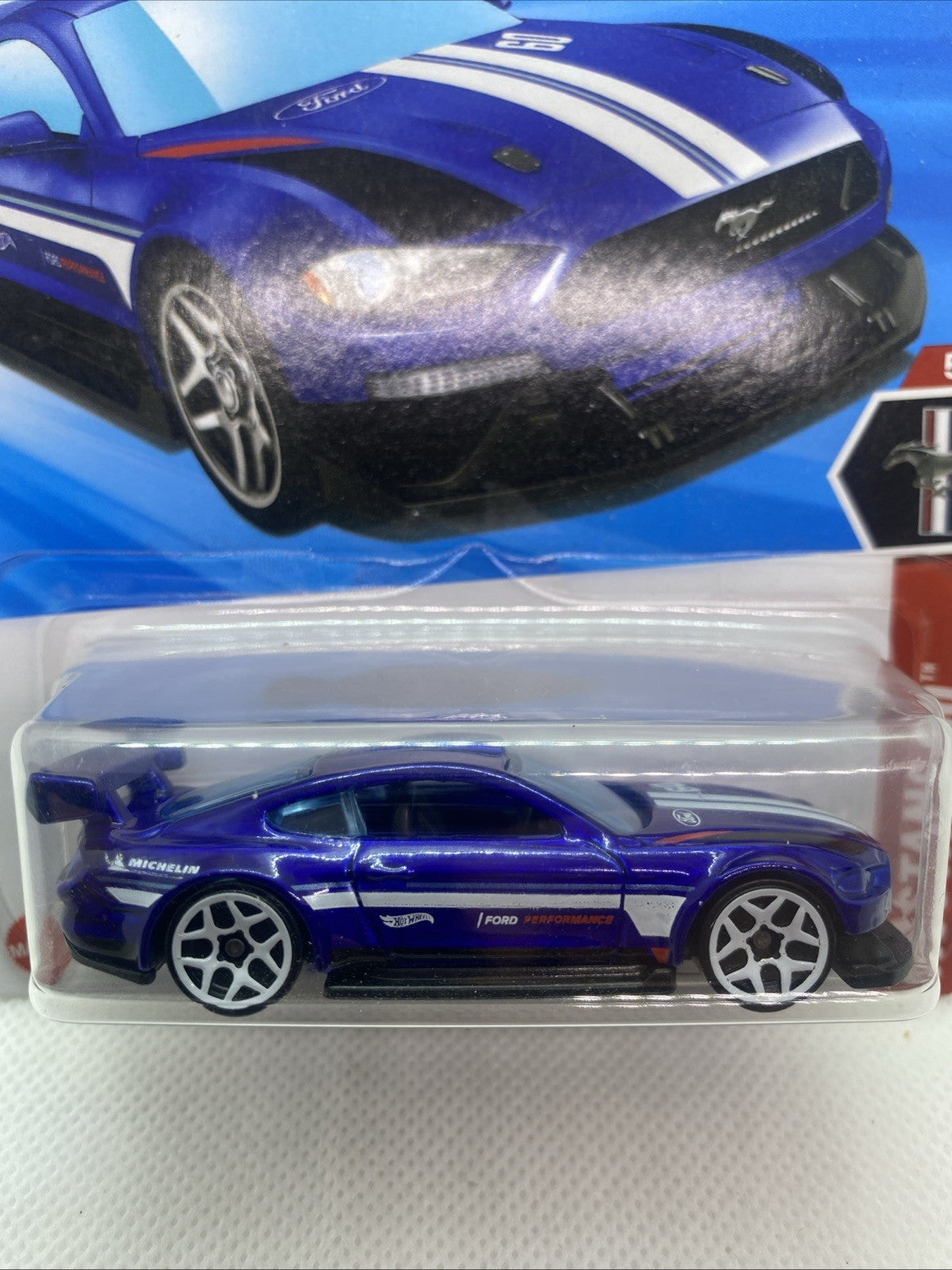 Close-up of Hot Wheels blue Mustang-style die-cast car in clear blister