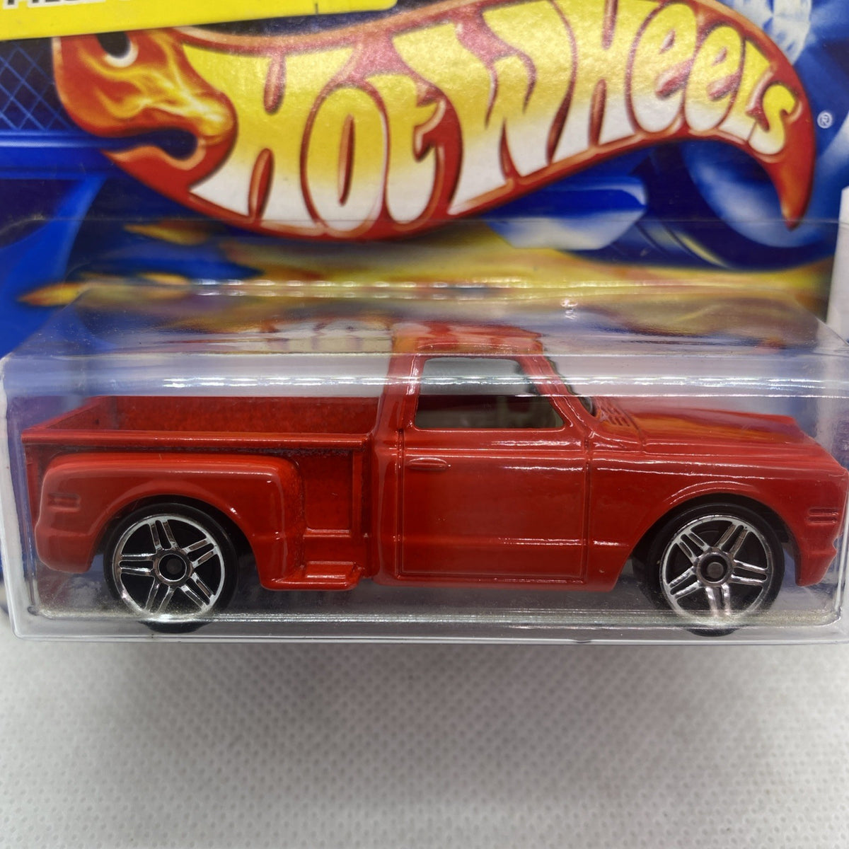 Close-up of red Hot Wheels die-cast car in clear blister with chrome wheels
