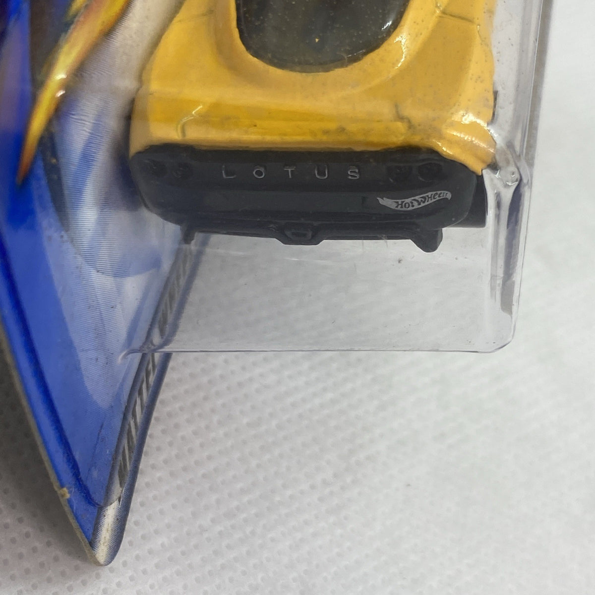 Close-up of yellow car rear in clear blister pack