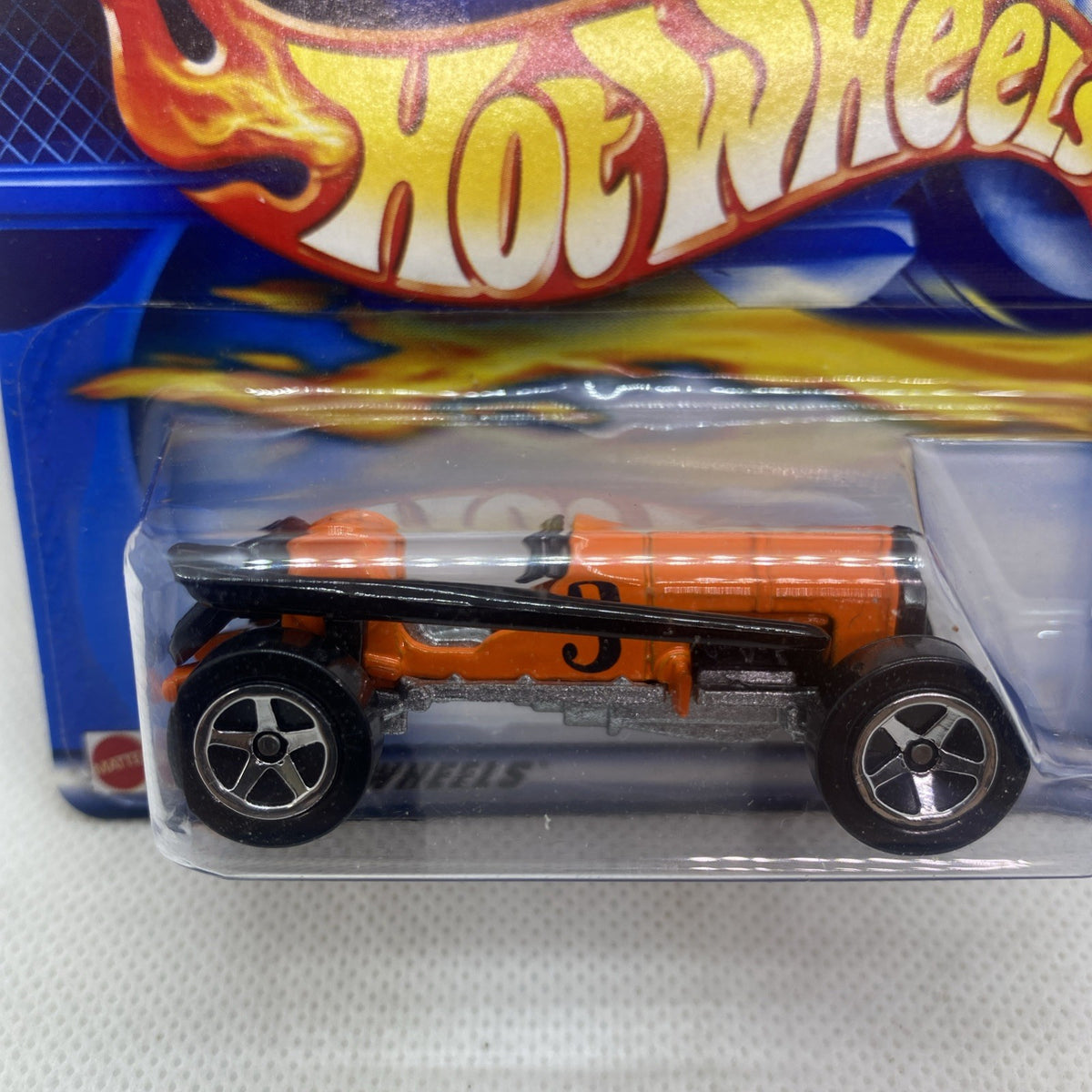 Hot Wheels orange die-cast car close-up in clear blister, detailed flame styling