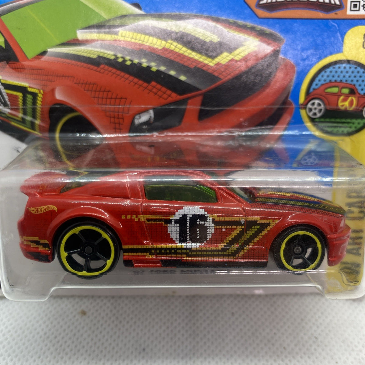 Close-up red Hot Wheels Mustang art car with black wheels, sealed blister
