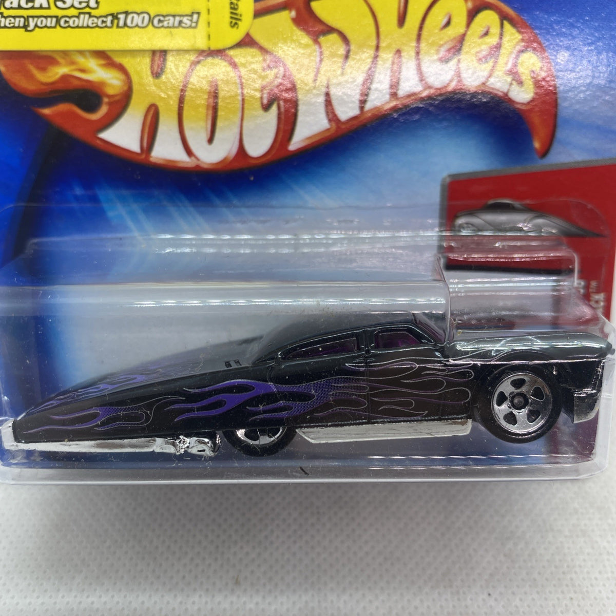 Black flame Hot Wheels die-cast car side view in clear blister packaging