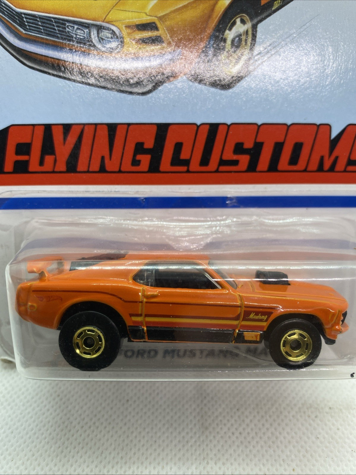 Orange Hot Wheels '70 Ford Mustang Mach 1 die-cast in clear blister, side profile
