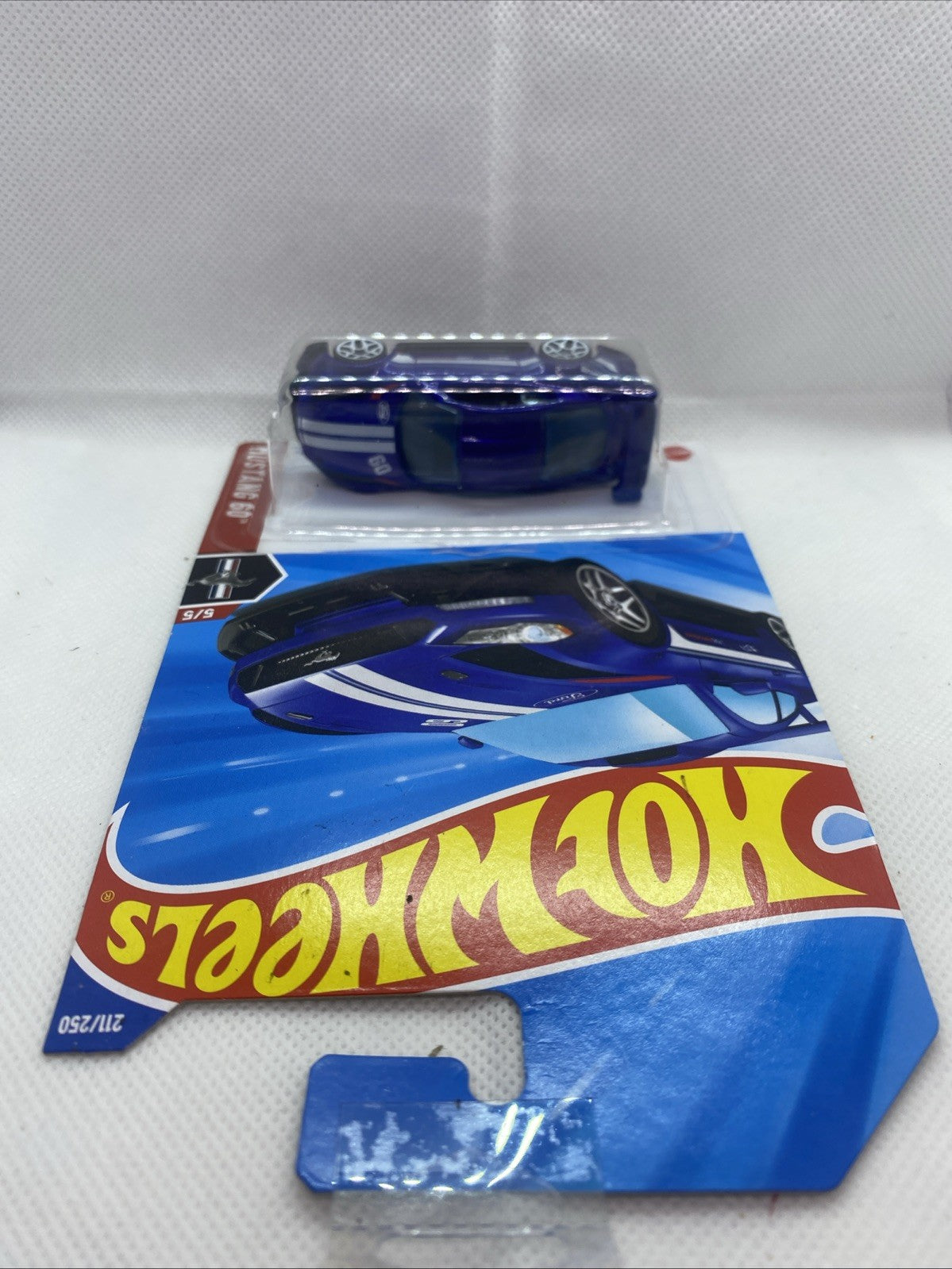 Hot Wheels short card with blue muscle car blister pack laid flat