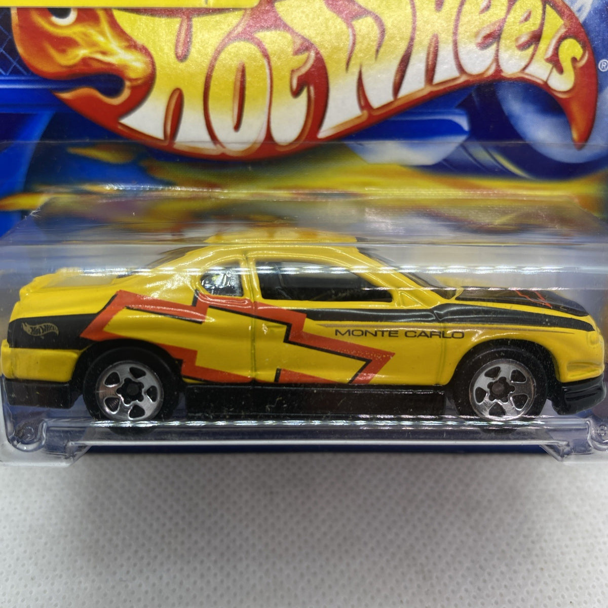 Hot Wheels yellow Monte Carlo concept car with Monte Carlo door text, close-up