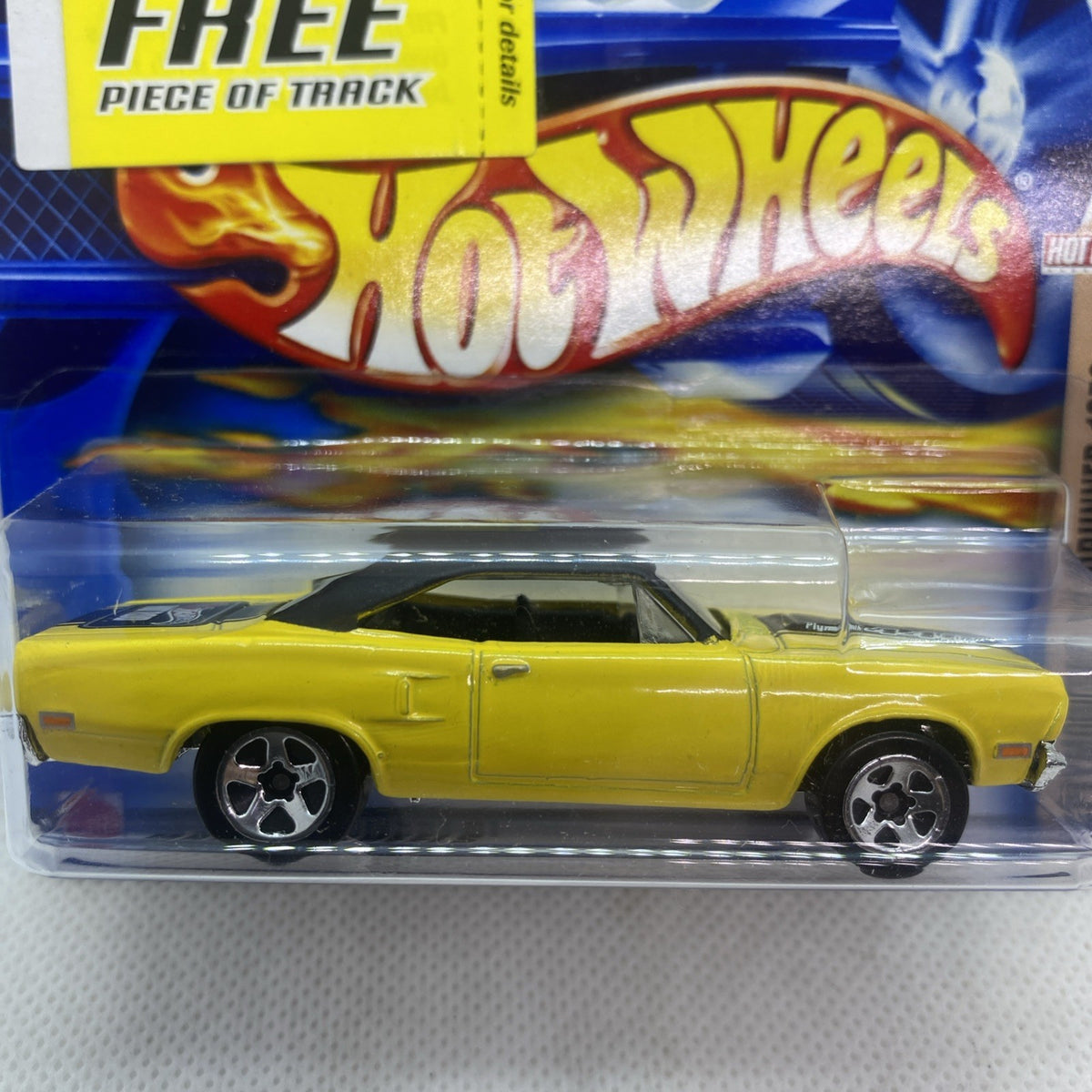 Close-up of yellow Plymouth Roadrunner 1970 die-cast car with chrome wheels
