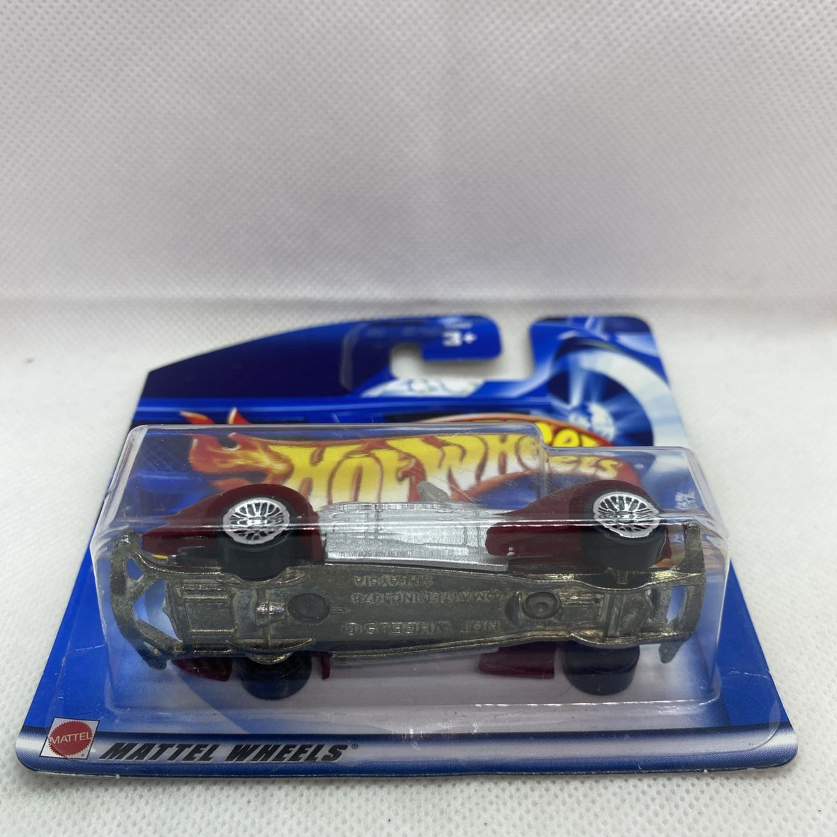 Hot Wheels Auburn 852 die-cast car in clear blister on blue card, underside view