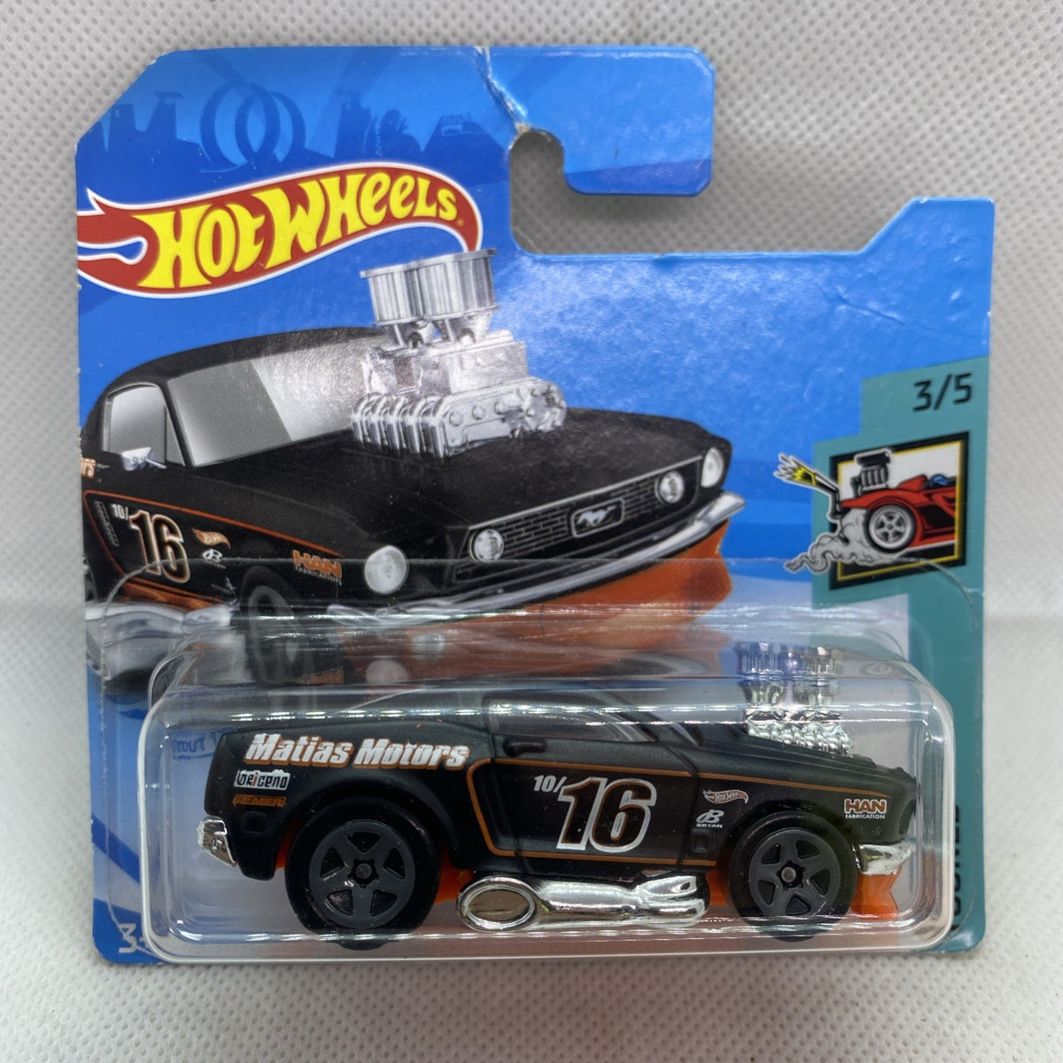 Hot Wheels ’68 Mustang die-cast in clear blister on blue short card, black with orange