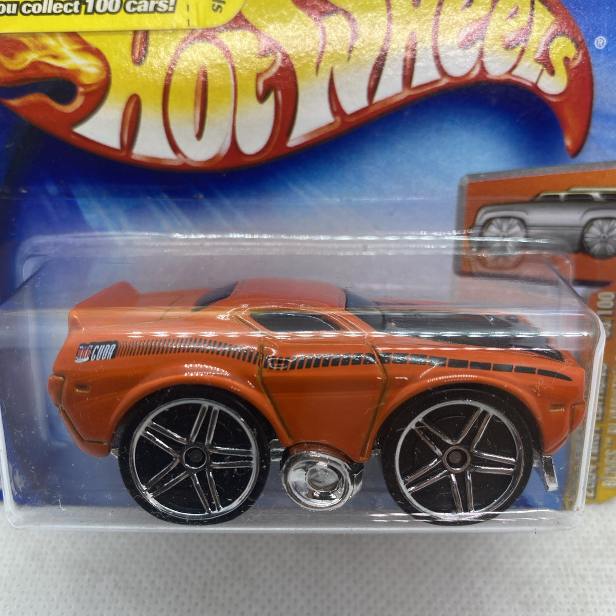Hot Wheels orange die-cast muscle car close-up in clear blister with chrome wheels