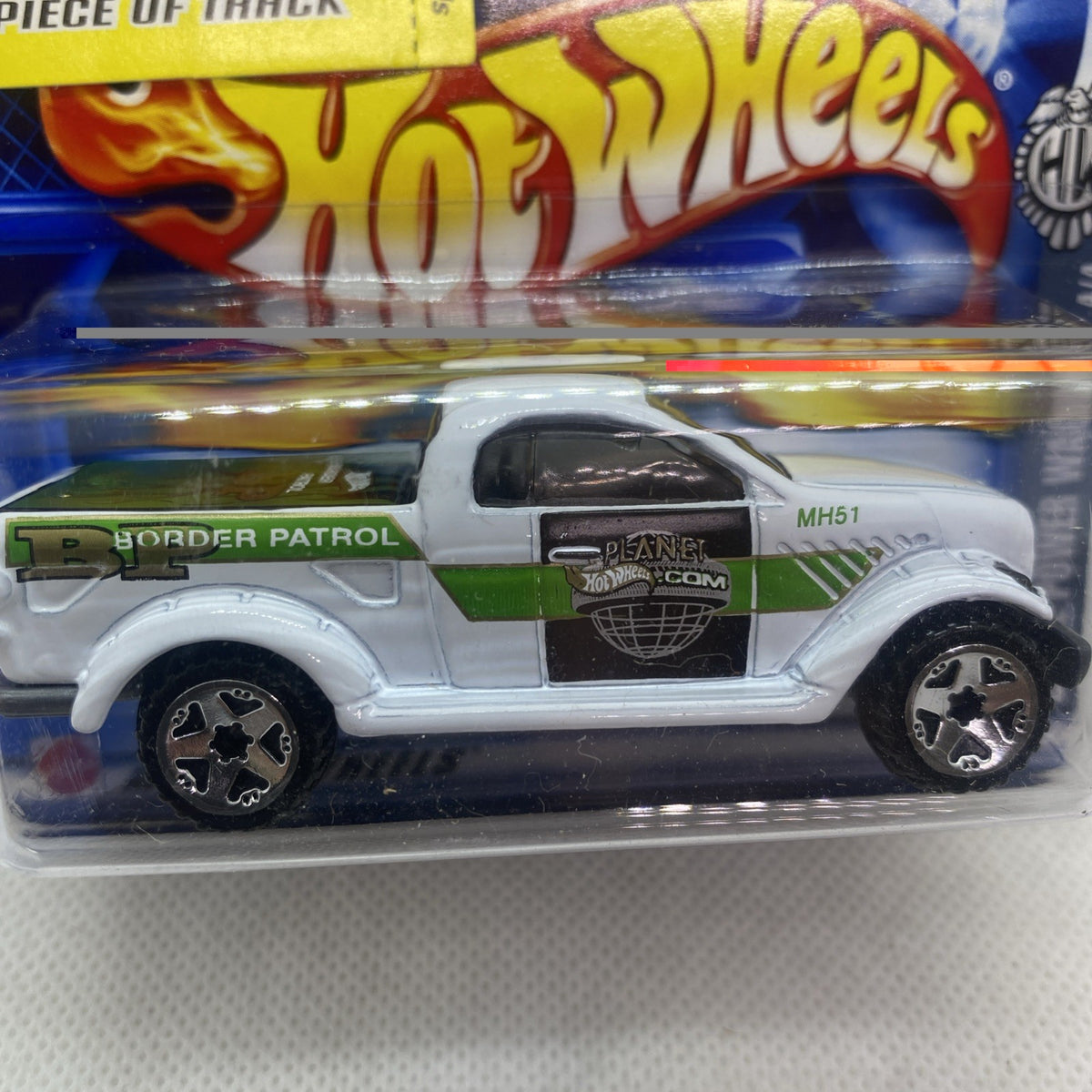 Hot Wheels die-cast truck close-up, white with green BORDER PATROL stripe