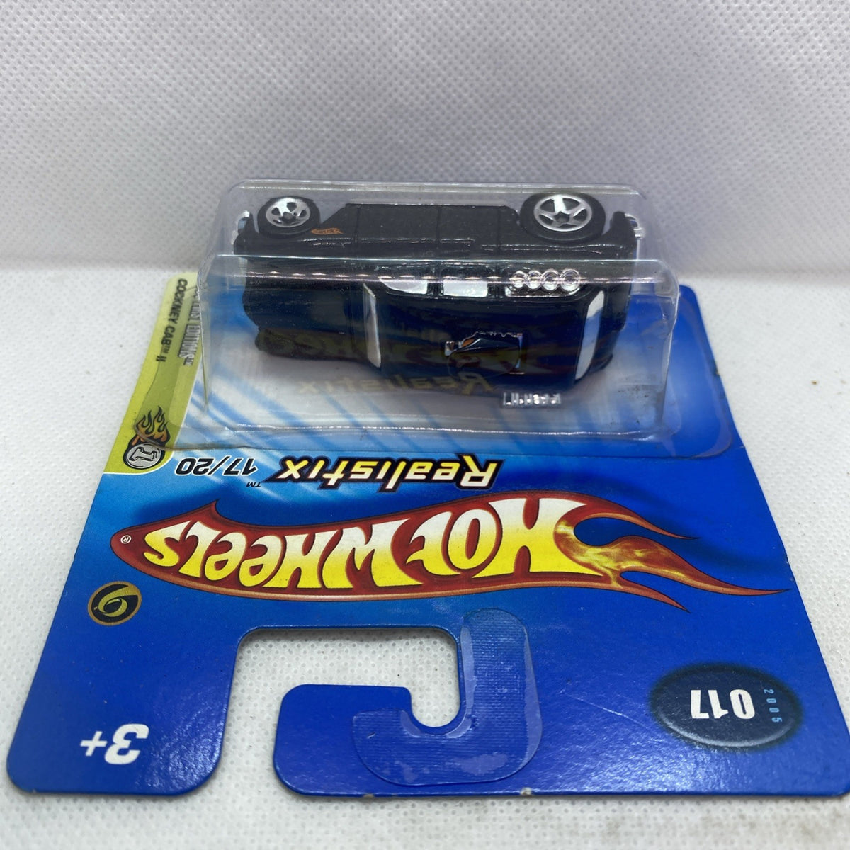 Hot Wheels die-cast car side view in clear blister on trading card