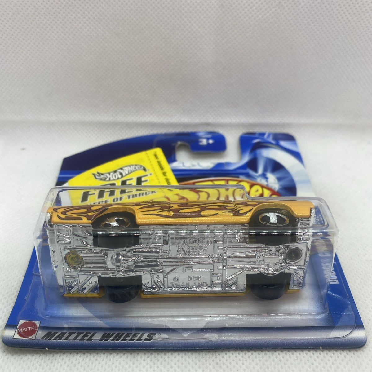 Hot Wheels die-cast car showing underside details in clear blister card