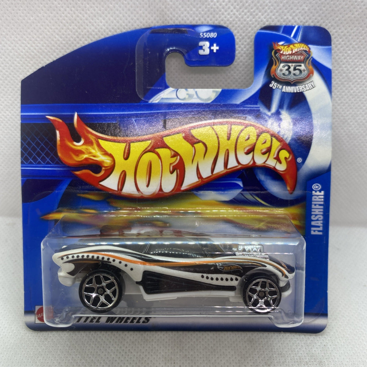 Hot Wheels die-cast car on blue card blister, white race car with black accents