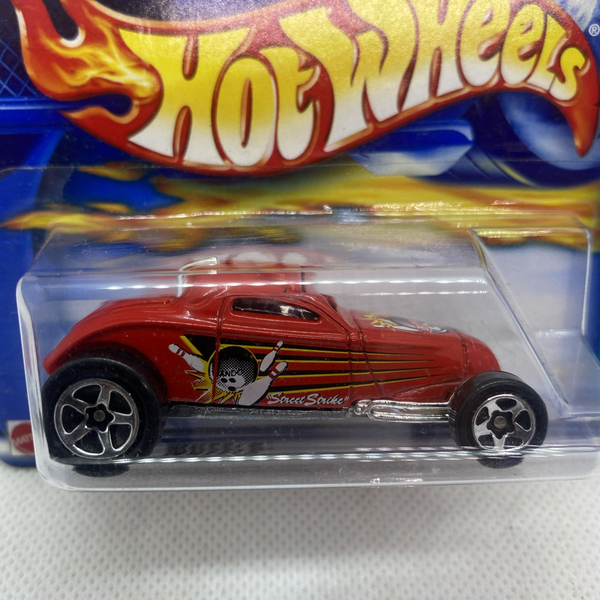 Hot Wheels red die-cast car with flame side graphics in clear blister