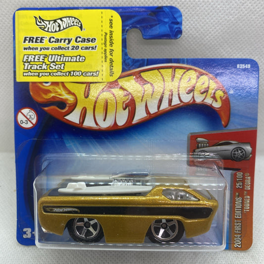 Hot Wheels First Edition gold and black car in front blister pack, sealed