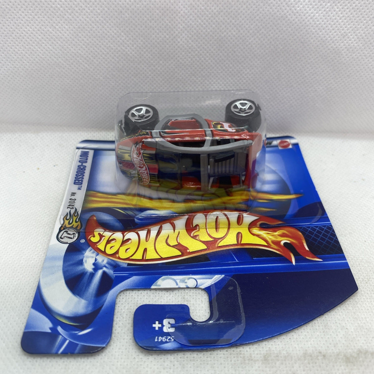 Hot Wheels motocross car in clear blister on blue card, car facing left