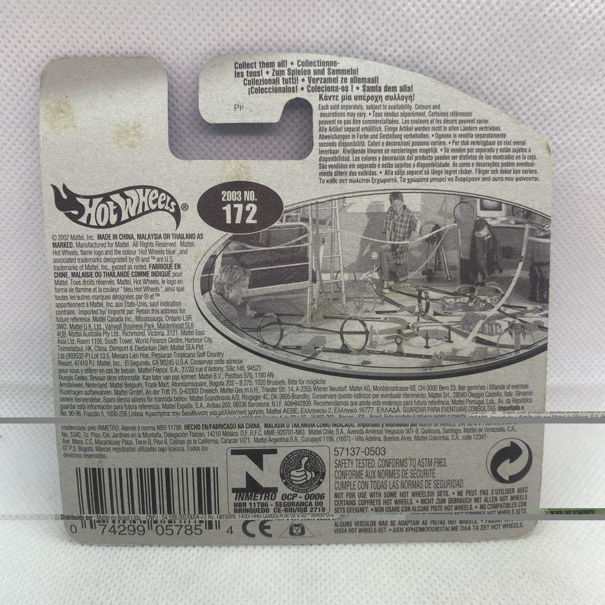 Hot Wheels die-cast car card back with barcode, text, and illustrated vehicle scene