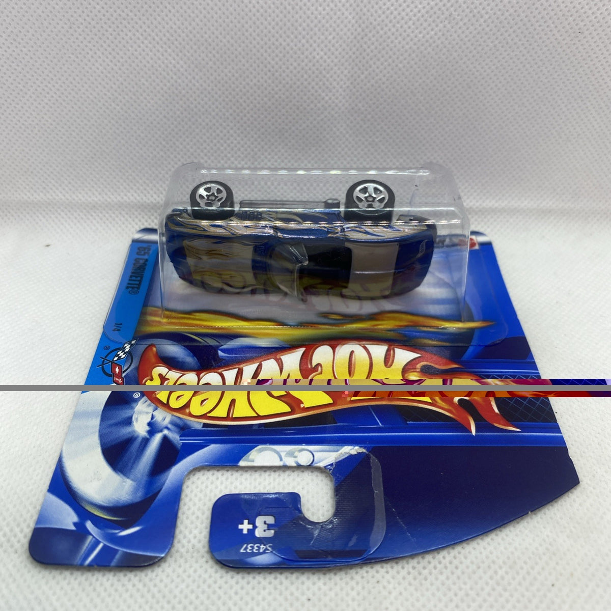 Hot Wheels die-cast Corvette in blue blister on short card, rear view with wheels up