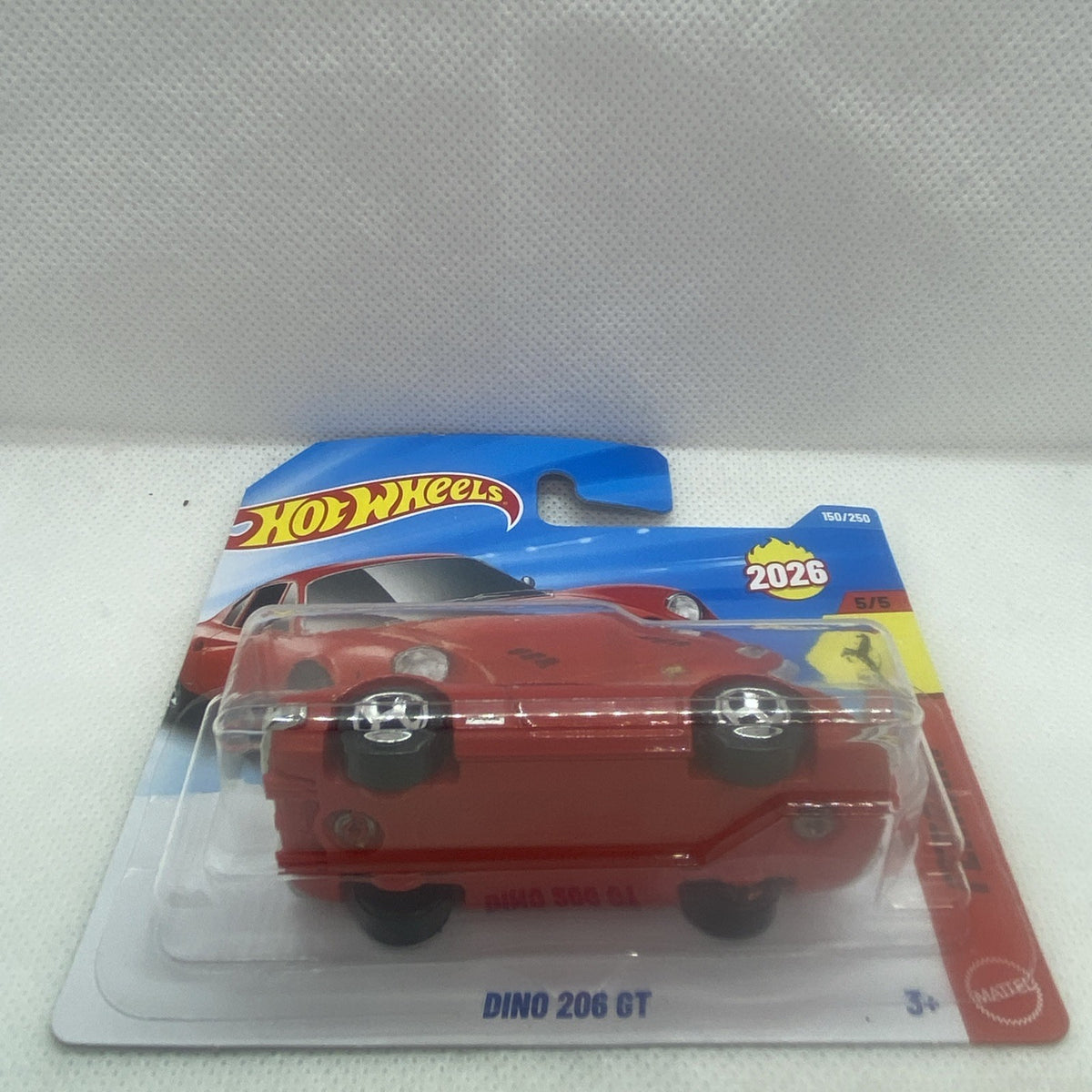 Red die-cast sports car on Hot Wheels card, side front view in clear blister.