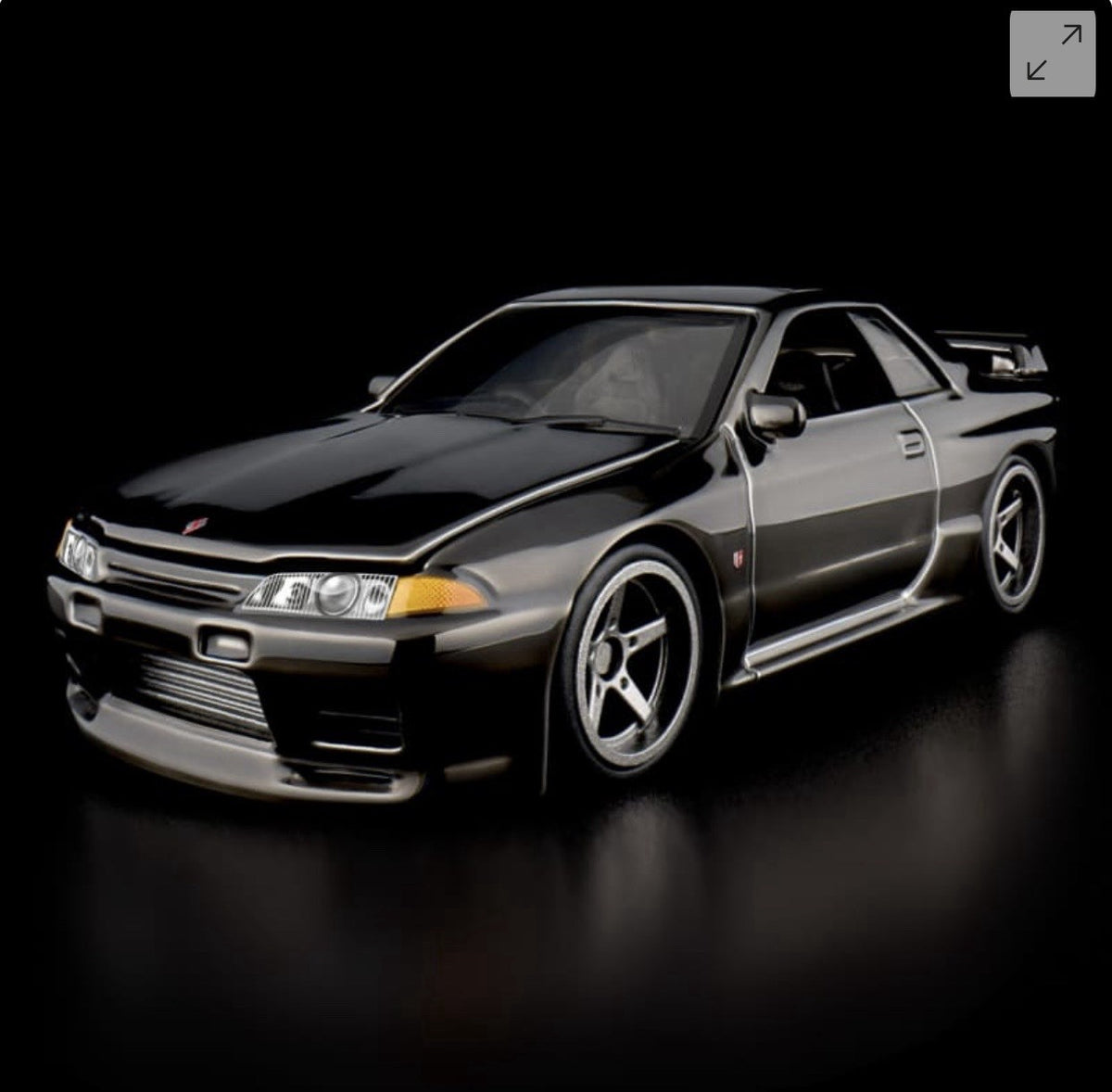 Die-cast sports car model, front-left three-quarter view with chrome grille and fog lights