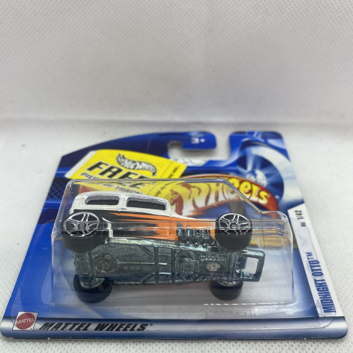 Hot Wheels Midnight Otto die-cast car front view in sealed blister pack with flame accents
