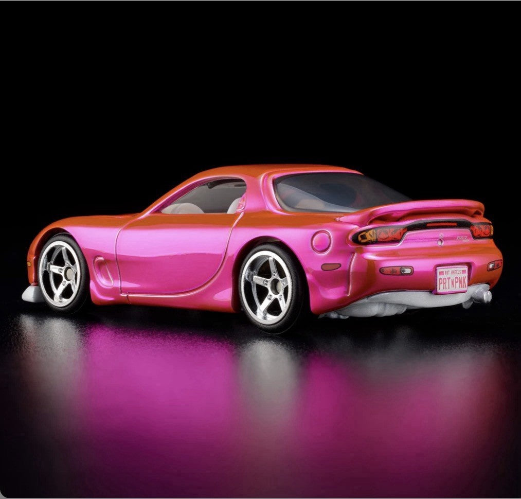 Pink and orange die-cast sports car with chrome wheels, rear 3/4 view