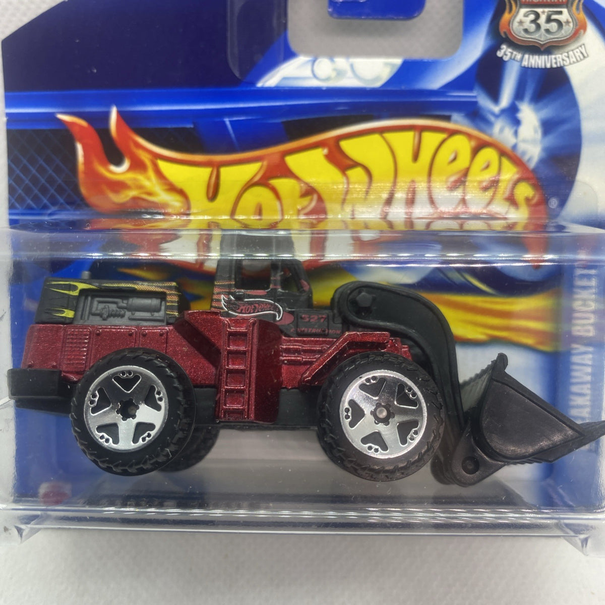 Red and black toy truck in clear blister, flame graphics and Hot Wheels logo visible