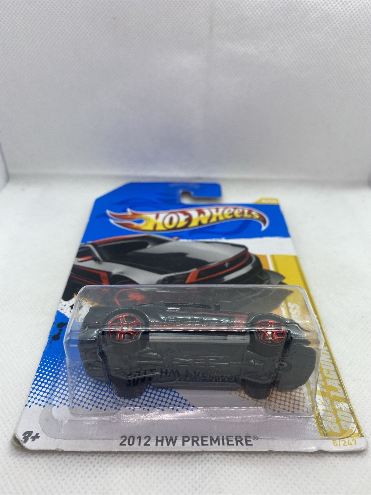 Hot Wheels HW Premiere blister showing black sports car with red wheels