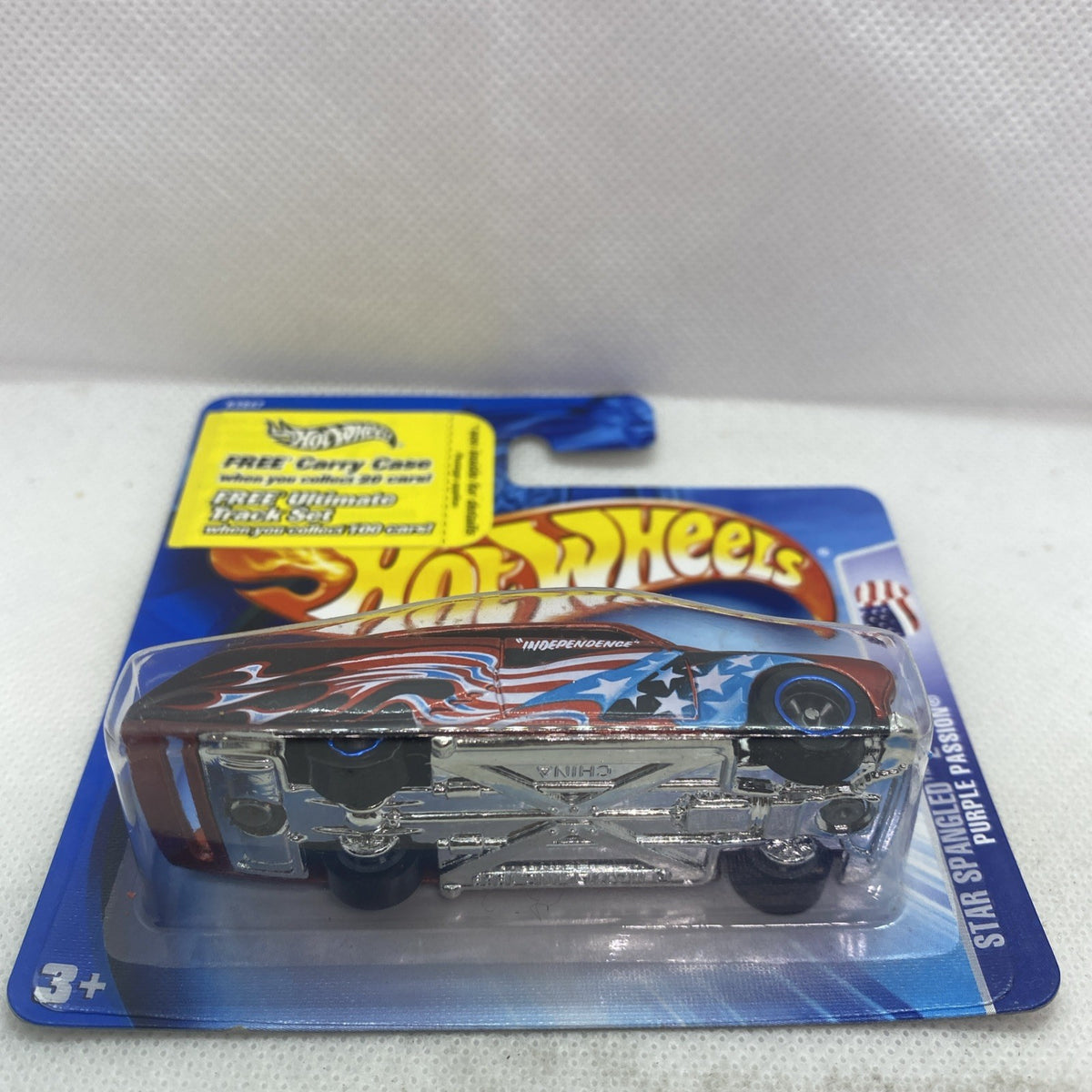 Hot Wheels Star Spangled toy car on card, red and black body with star graphics
