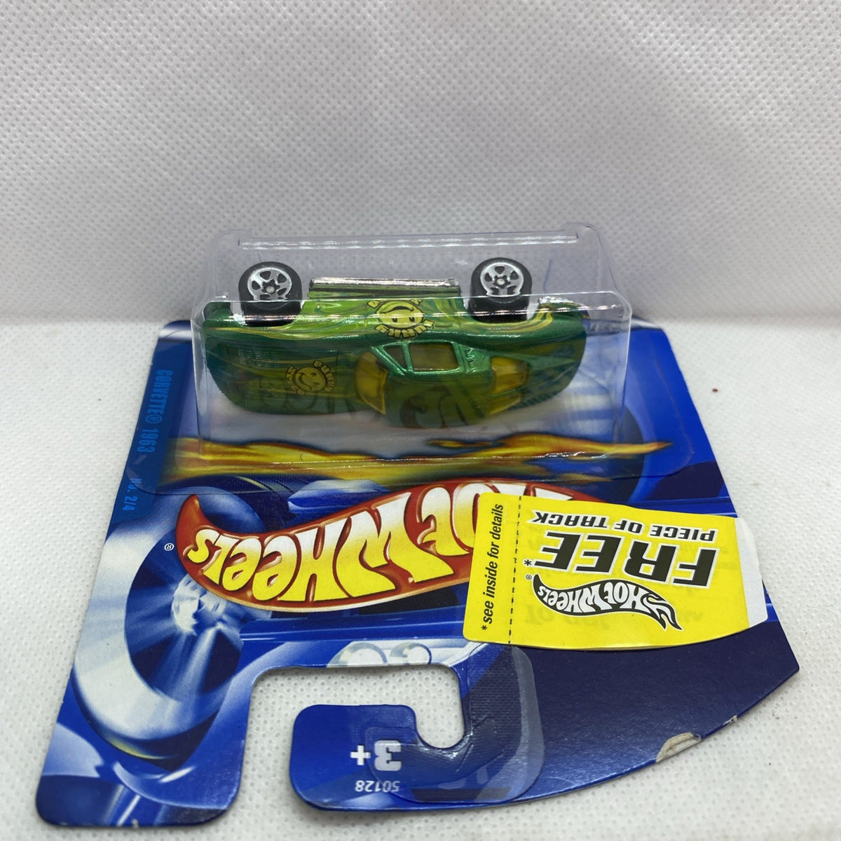 Sealed Hot Wheels green die-cast car in clear blister on blue card backing