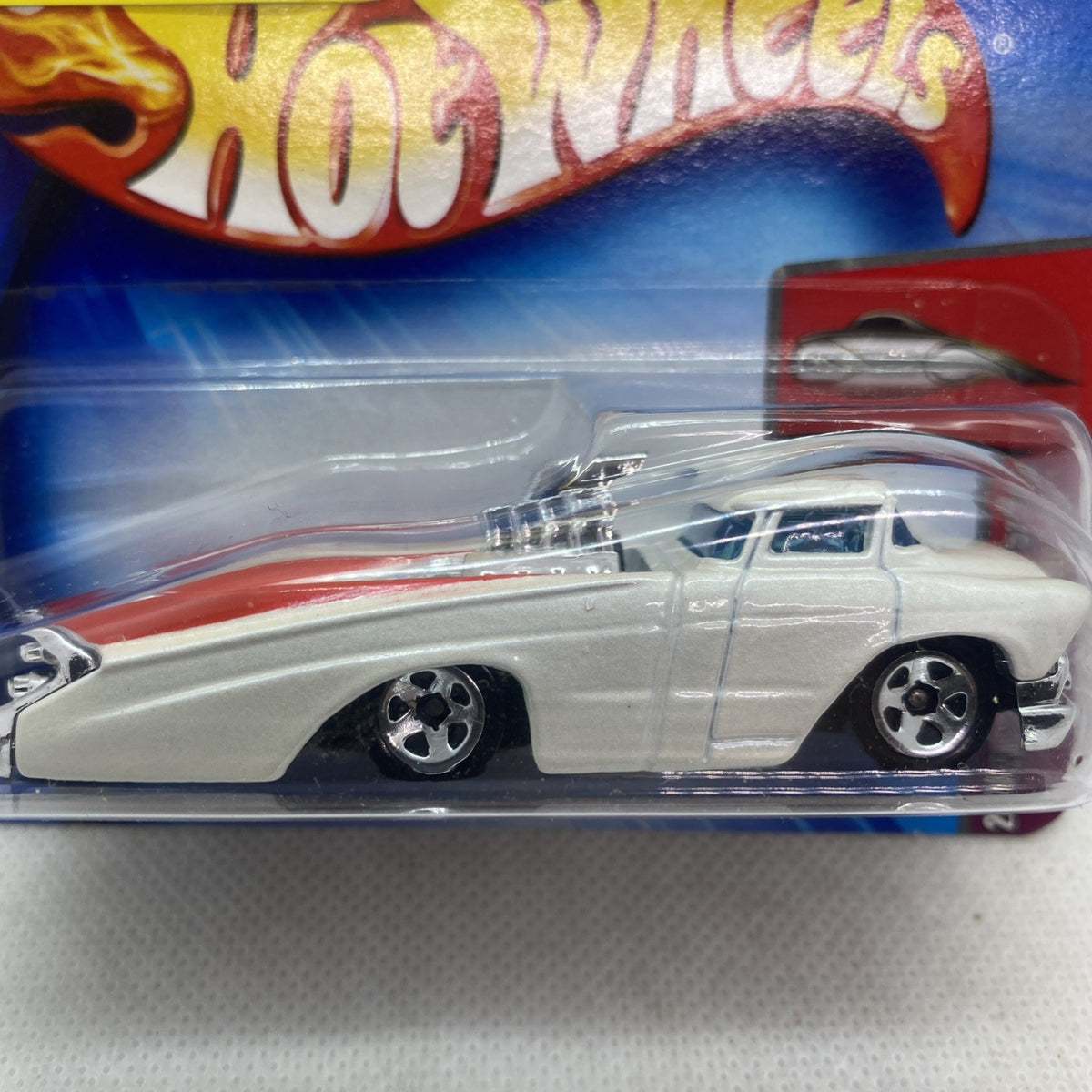 Close-up of Hot Wheels white coupe with chrome parts and black wheel rims